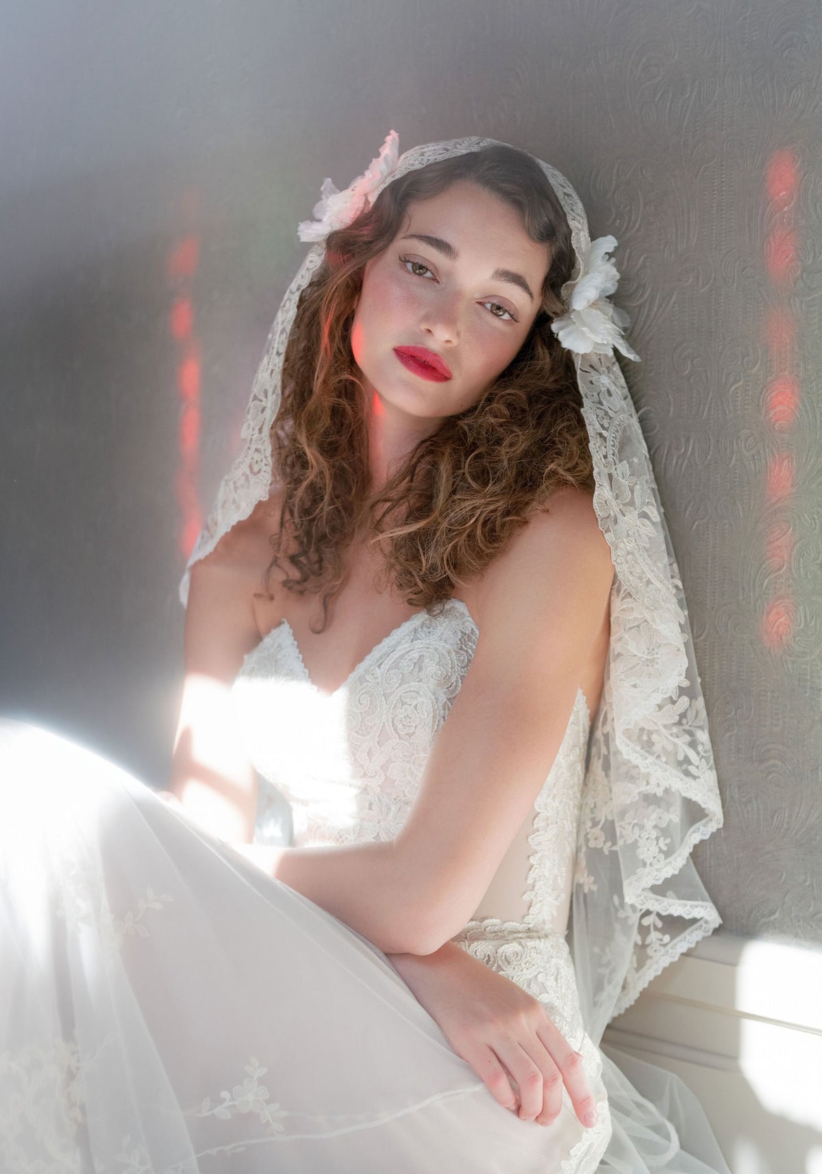 Bride in the Sonnet embroidered lace veil framing the face and shoulders