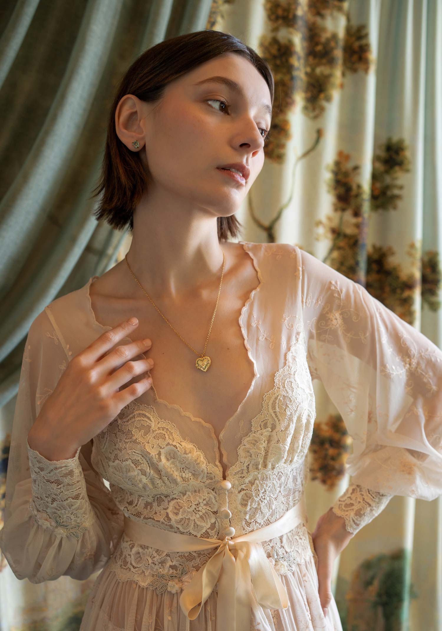 Sheer tulle boudoir robe with champagne floral embroidery and ivory lace inlays on a model.