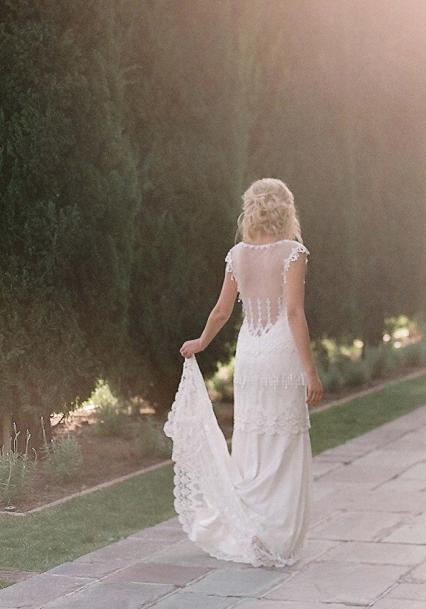 Bride holding a train of the Kristene wedding dress