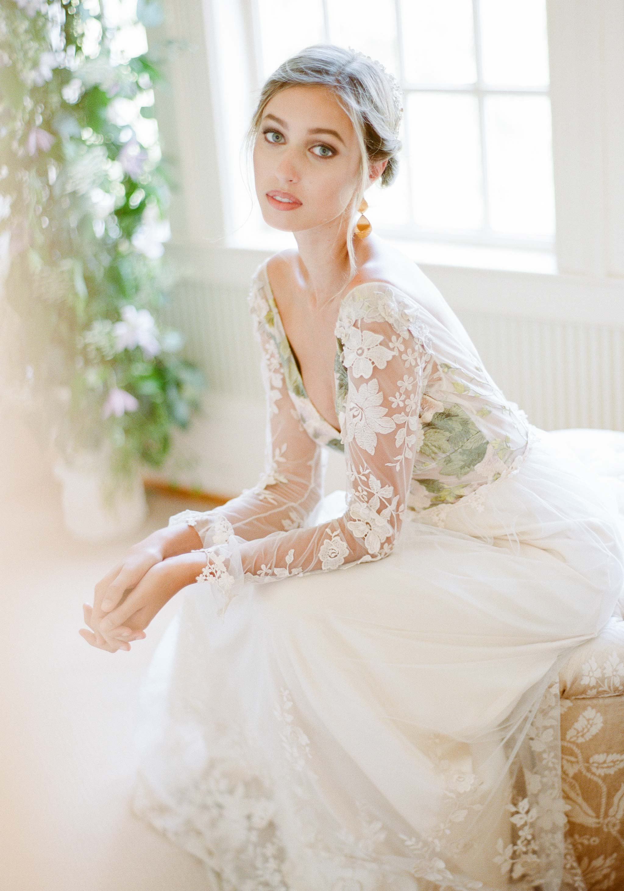 Model seated wearing the Primavera wedding dress