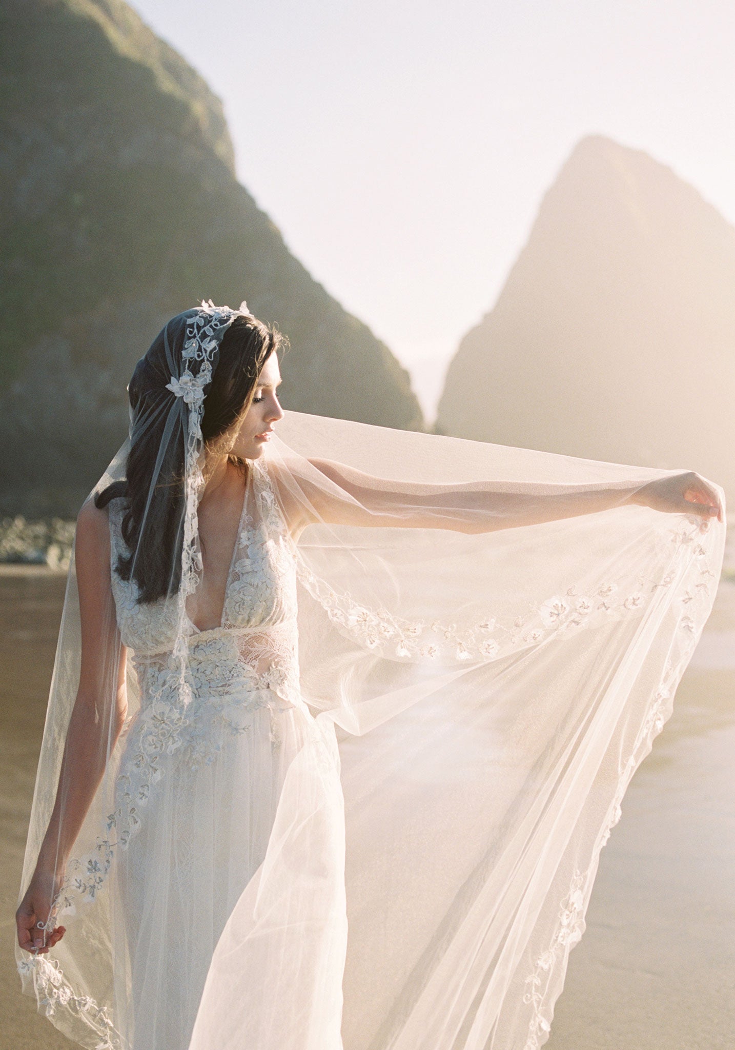 Bride in Champagne wedding dress hold edge of veil