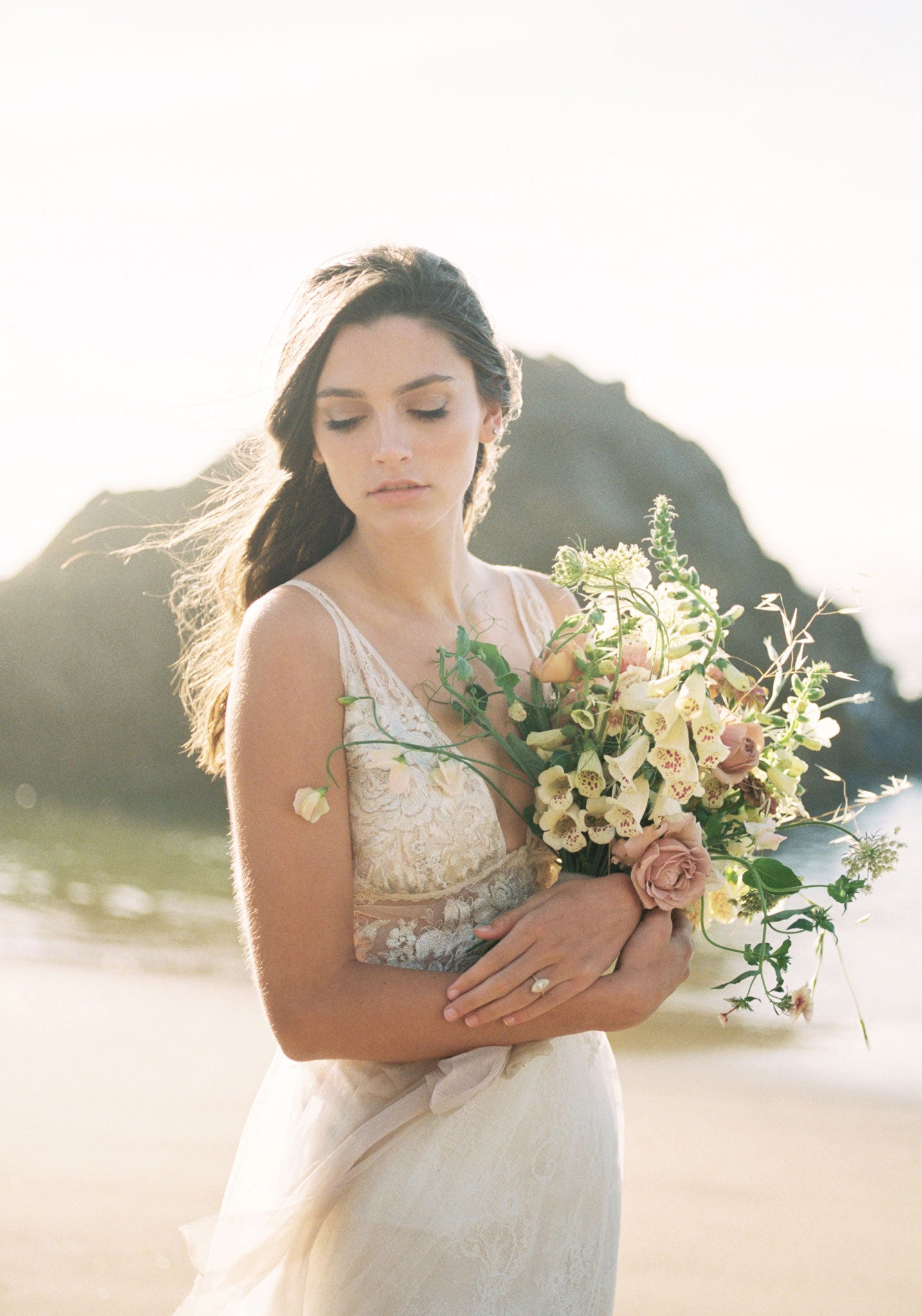 Bride holding wedding florals in Champagne wedding dress