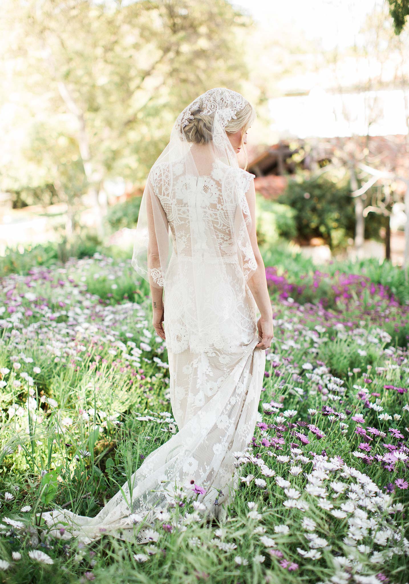 Lace wedding dress worn in outdoor garden setting