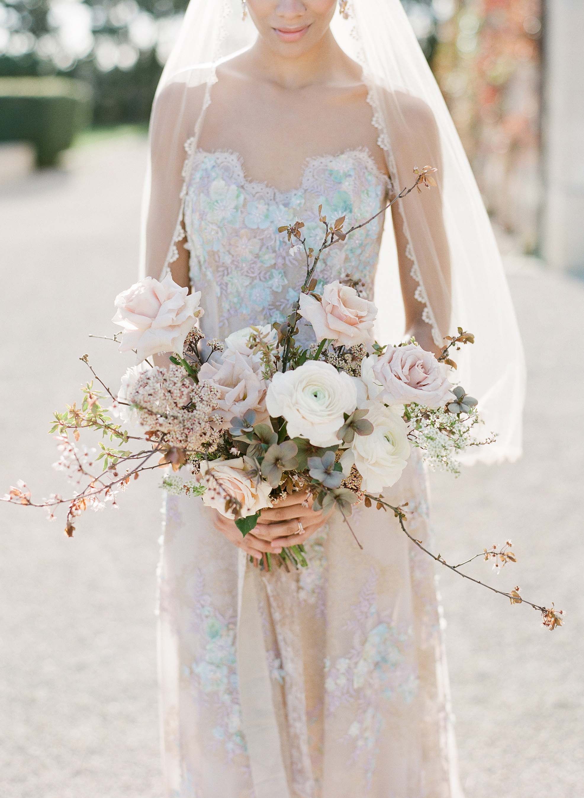 Bride holding wedding bouquet in colorful wedding dress Ophelia