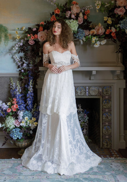 Amourette tiered French embroidered lace wedding dress with off-the-shoulder Guipure lace sleeves by Claire Pettibone