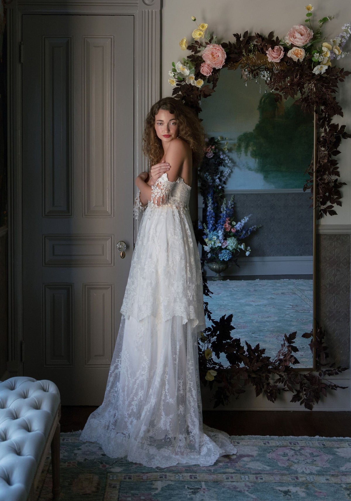 Side view of the Amourette tiered lace wedding dress with draped lace sleeves