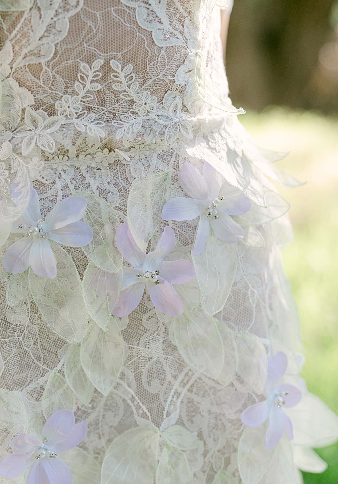 Detail of hand applied leaf appliques on the Everglade wedding dress overskirt