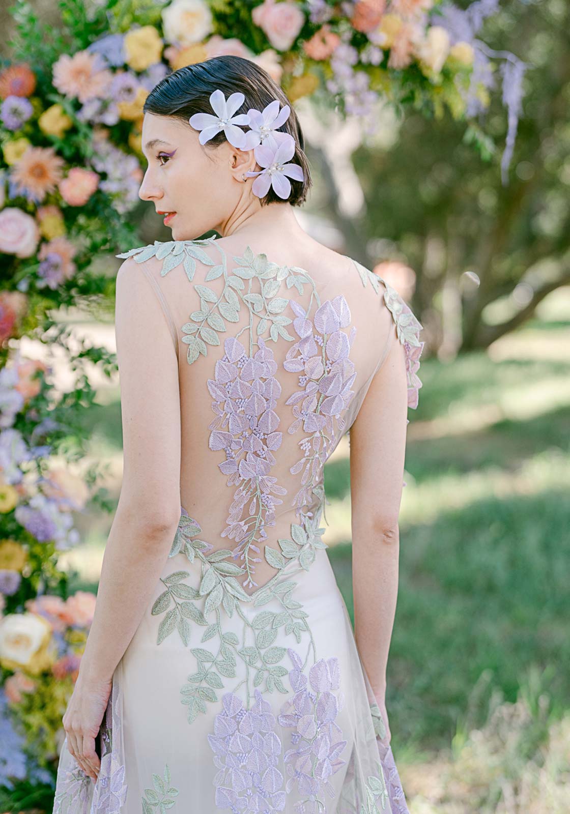 Back detail of colorful embroidery of the Wisteria designer couture wedding gown.