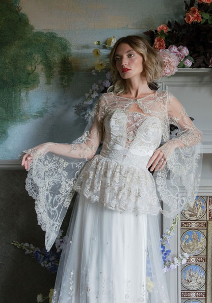 Filigree embroidered tulle bolero with bell sleeves worn over the Primrose gown by Claire Pettibone