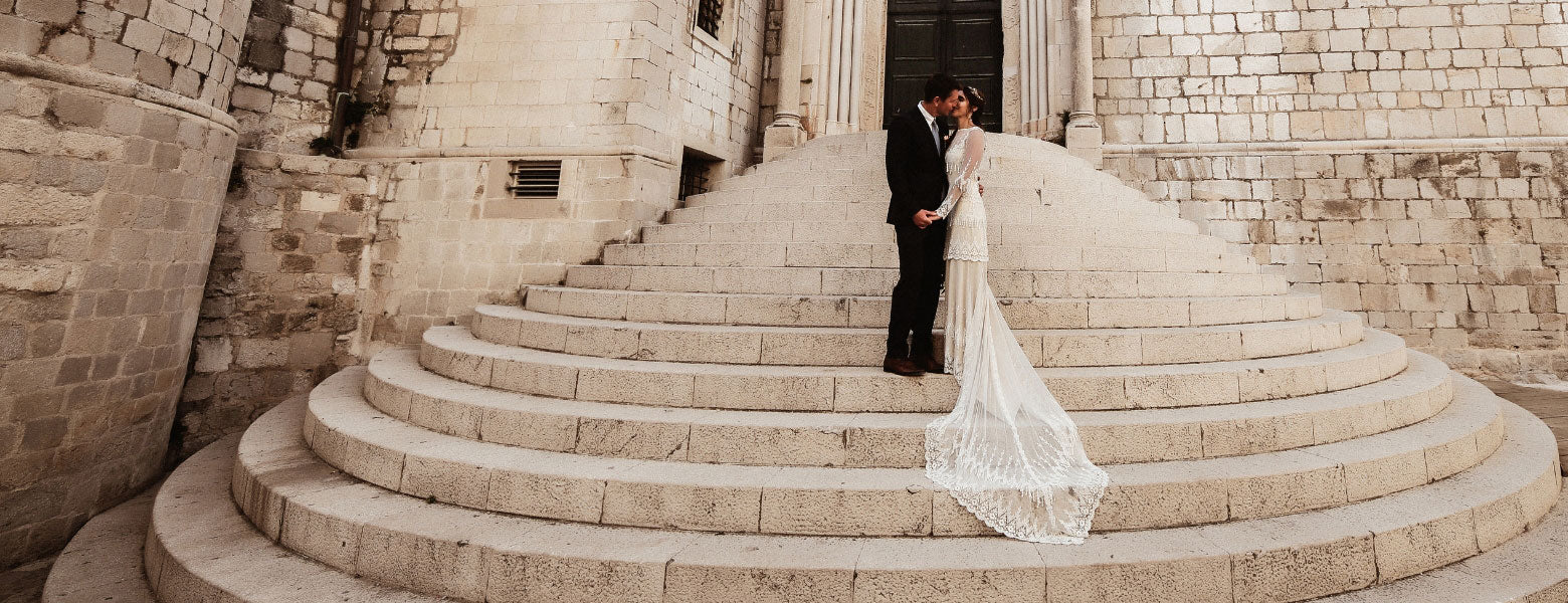 Custom Couture Vintage Style Wedding Dress Picture as Bride and Groom Kiss on Church Steps