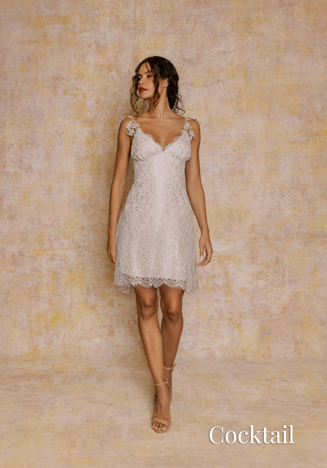 Cocktail length lace party dress in silver color.