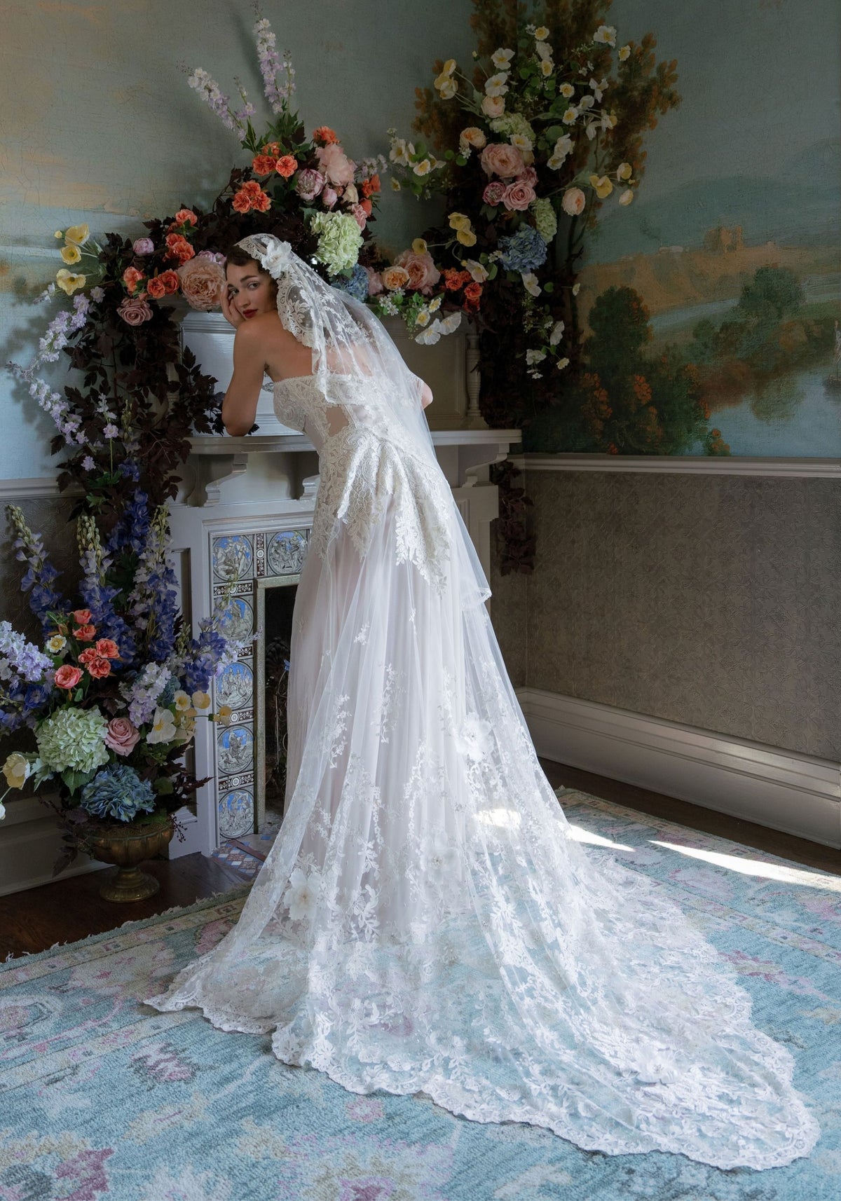 Back of the Narcisse wedding dress with lace mantilla veil and sweeping scalloped lace train