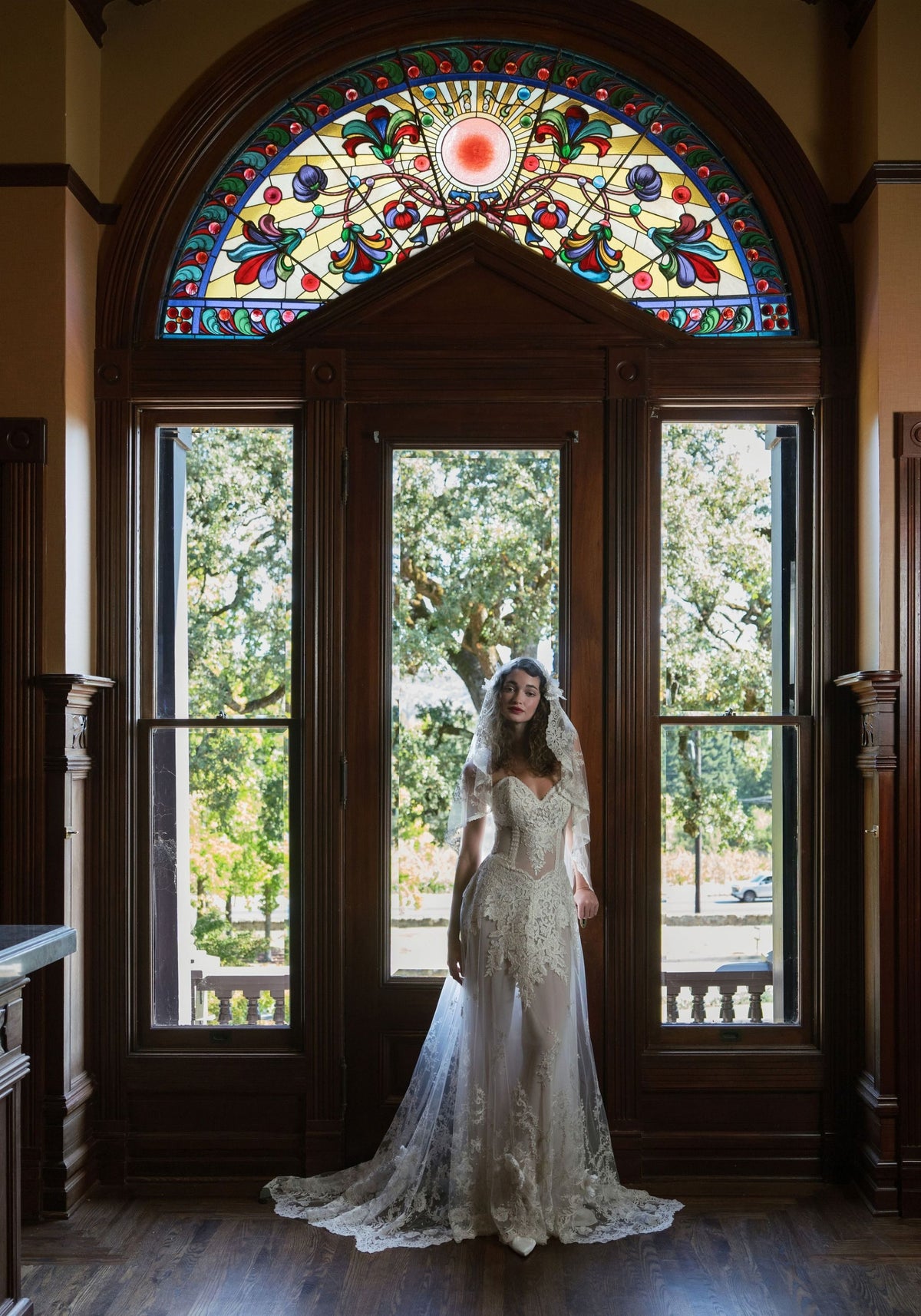 Narcisse wedding dress before the stained glass doors of the Rhine House, Beringer Vineyards