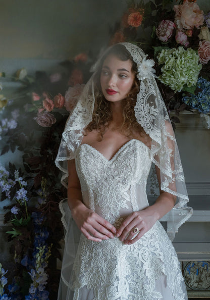 Bride in the Narcisse lace sweetheart bodice wearing a lace mantilla veil