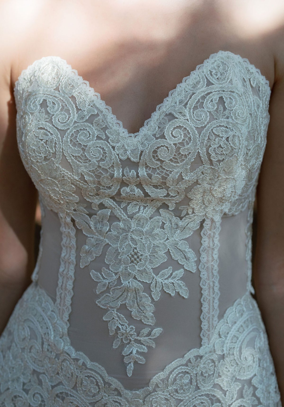 Close-up of the Narcisse sculpted sweetheart bodice with sheer lace insets and pointed basque waist