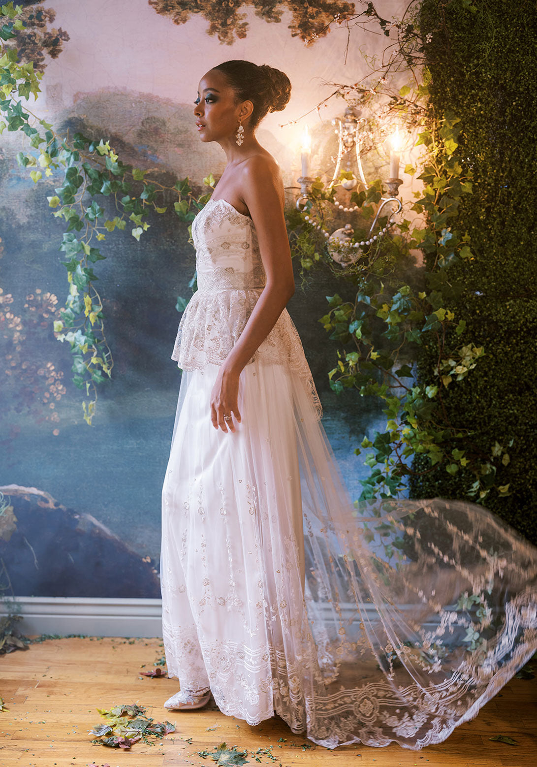 Side view of Claire Pettibone Primrose gown with embroidered lace and peplum detail.
