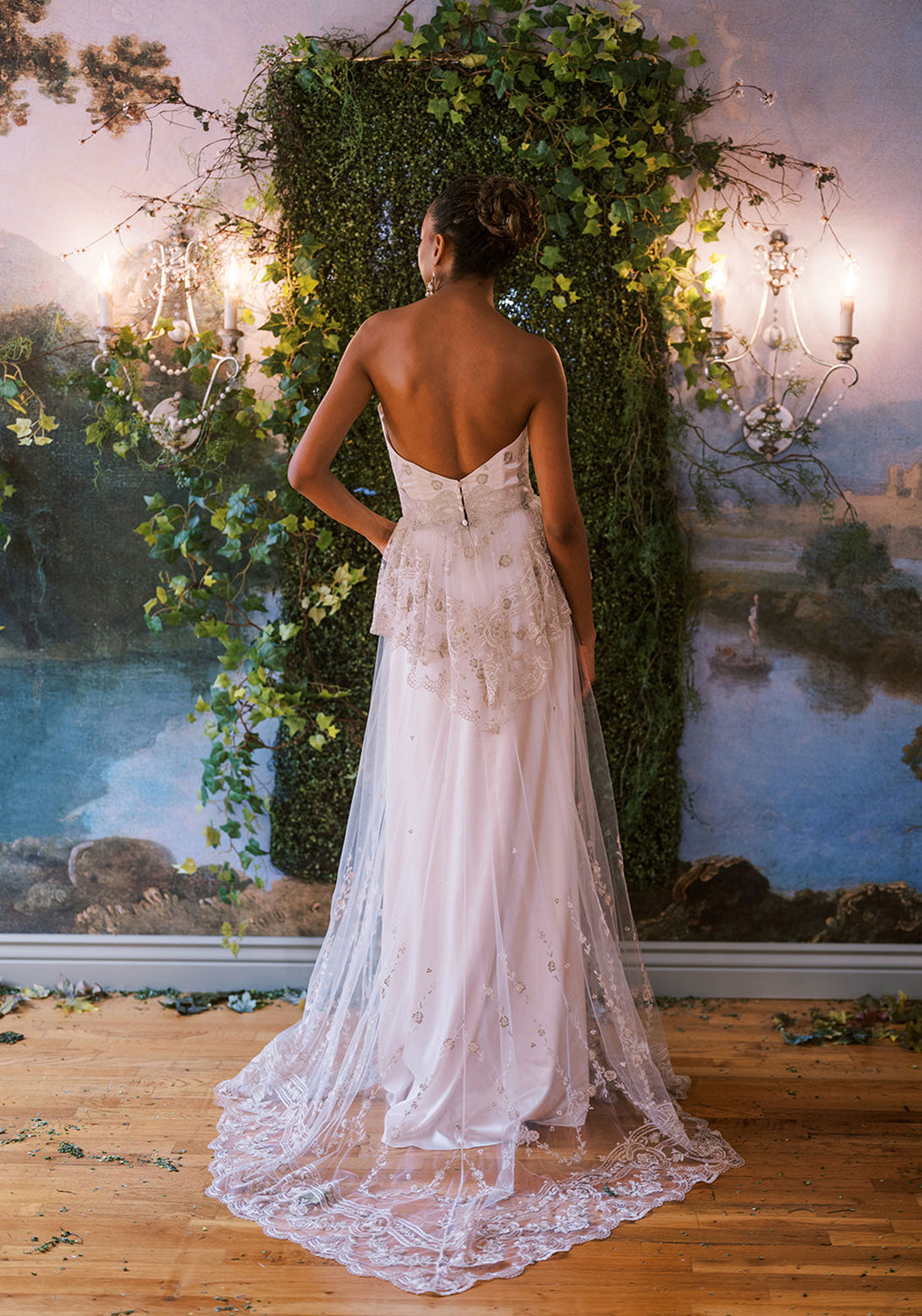 Back view of Primrose dress by Claire Pettibone with lace detail and embroidered train.
