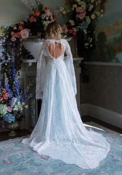 Open portrait back of the Serenade bell sleeve wedding dress with sweeping lace train