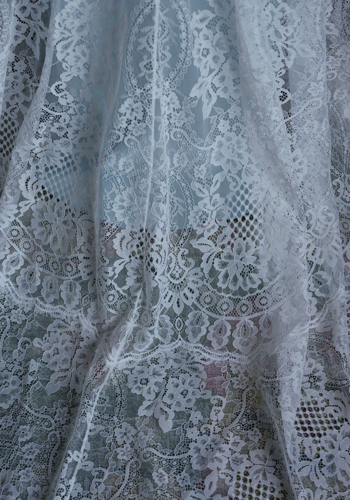 Close-up of the ivory floral lace on the Serenade wedding dress