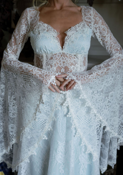 Detail of the Serenade scalloped lace sweetheart neckline, sheer waist and lace bell sleeves