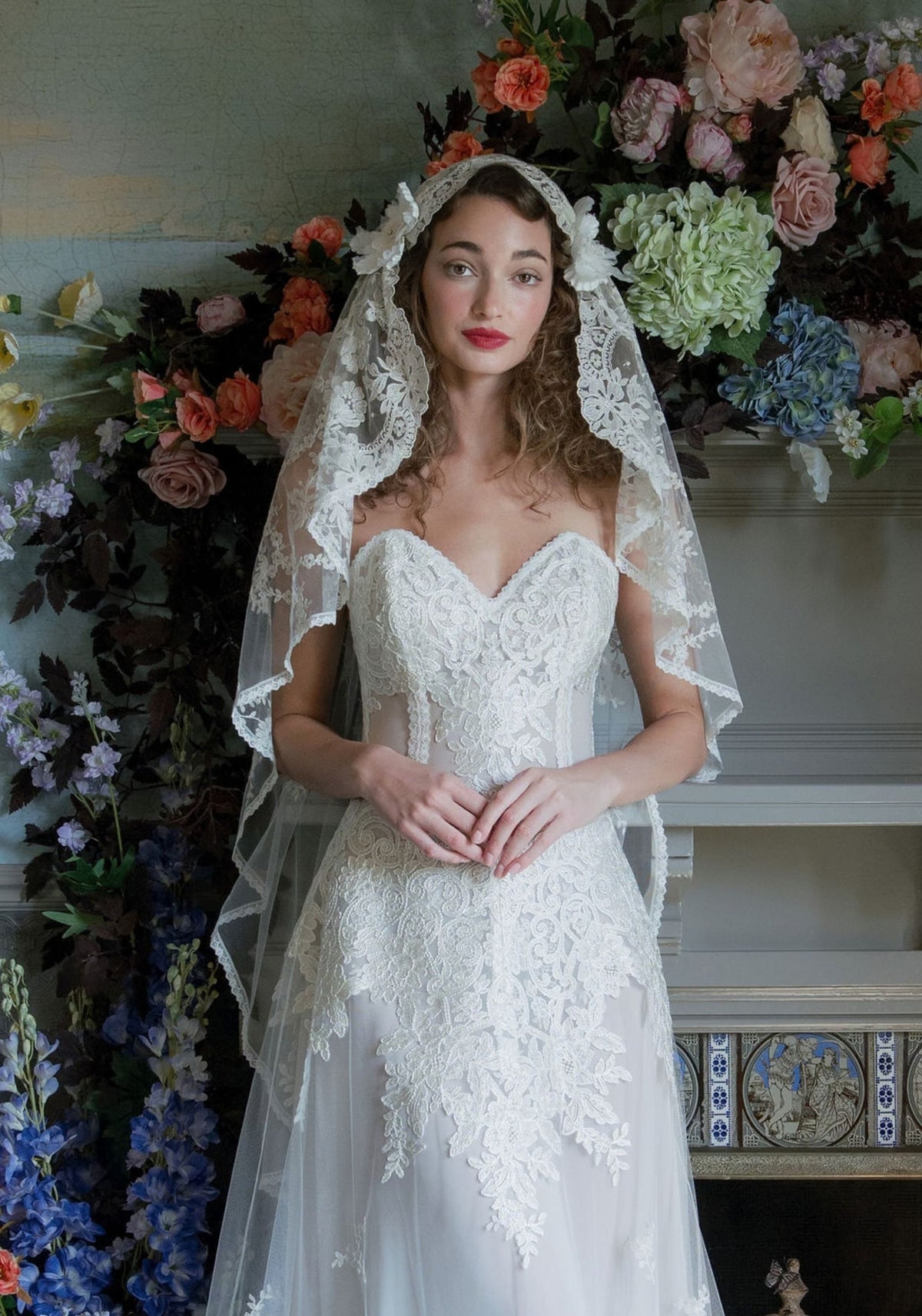 Sonnet lace mantilla wedding veil with silk flowers worn with the Narcisse gown by Claire Pettibone
