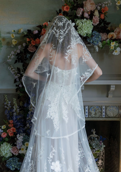 Back view of the Sonnet lace-edged veil draping over the shoulders