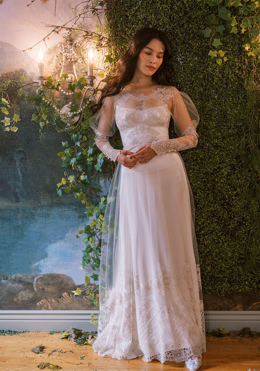 Trellis A-line gown with intricate lace detailing, long sheer sleeves, and delicate embroidery.