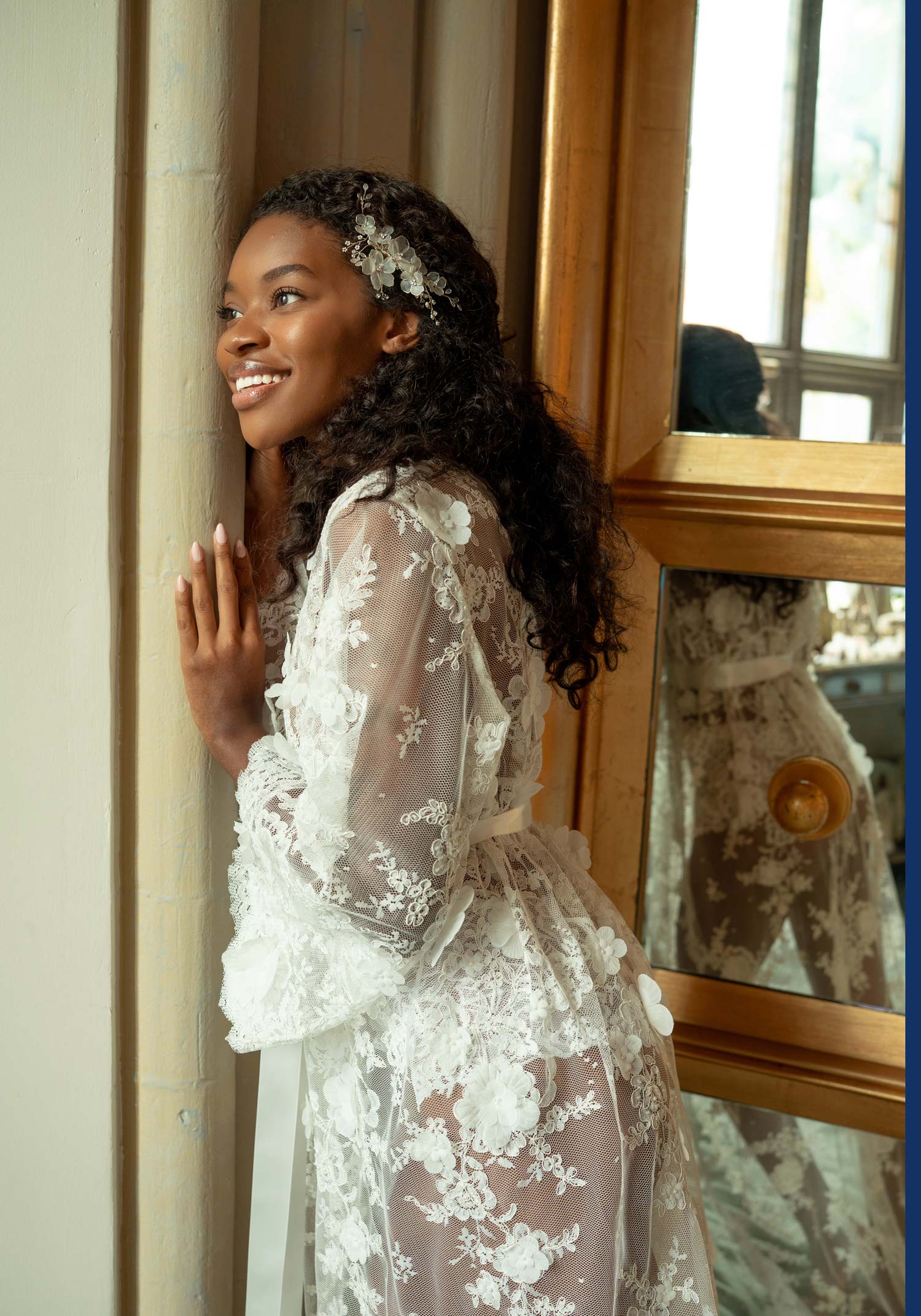 Floor-length white lace boudoir robe with intricate floral embroidery and sheer long sleeves.