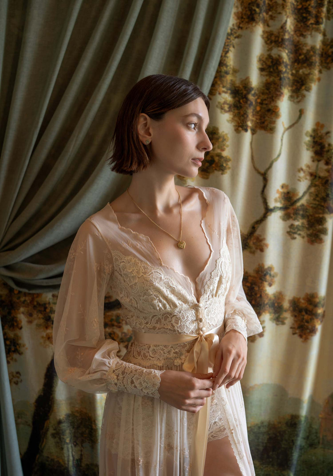 Sheer tulle boudoir robe with champagne floral embroidery and ivory lace inlays on a model.