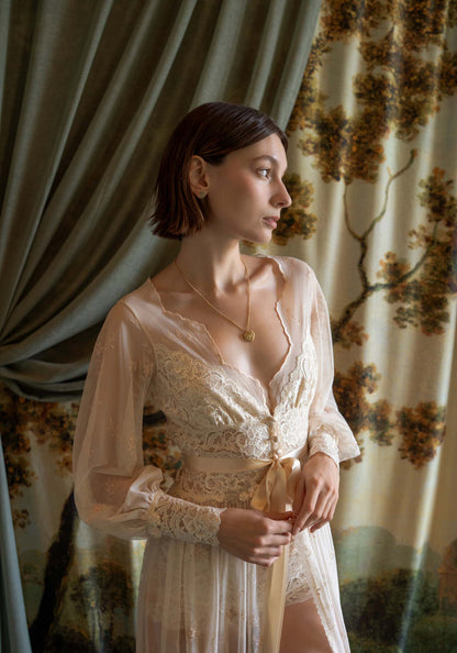 Sheer tulle boudoir robe with champagne floral embroidery and ivory lace inlays on a model.