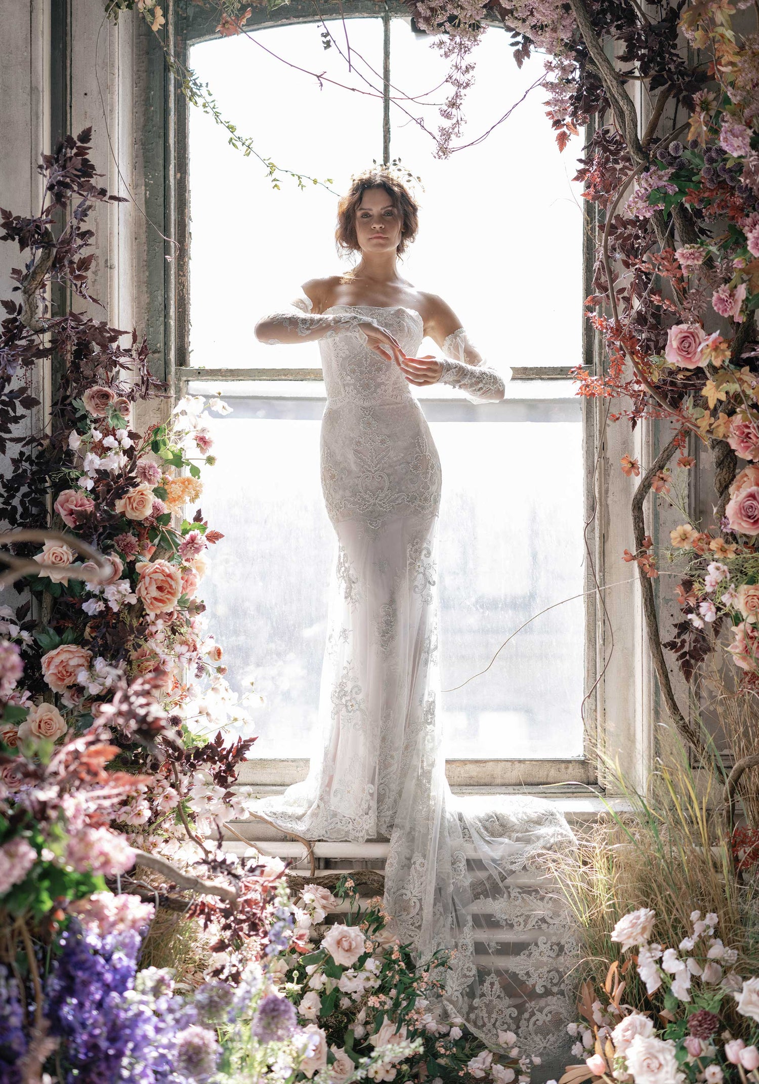 Model in Aquamarine mermaid style wedding dress surround by wedding floral decorations