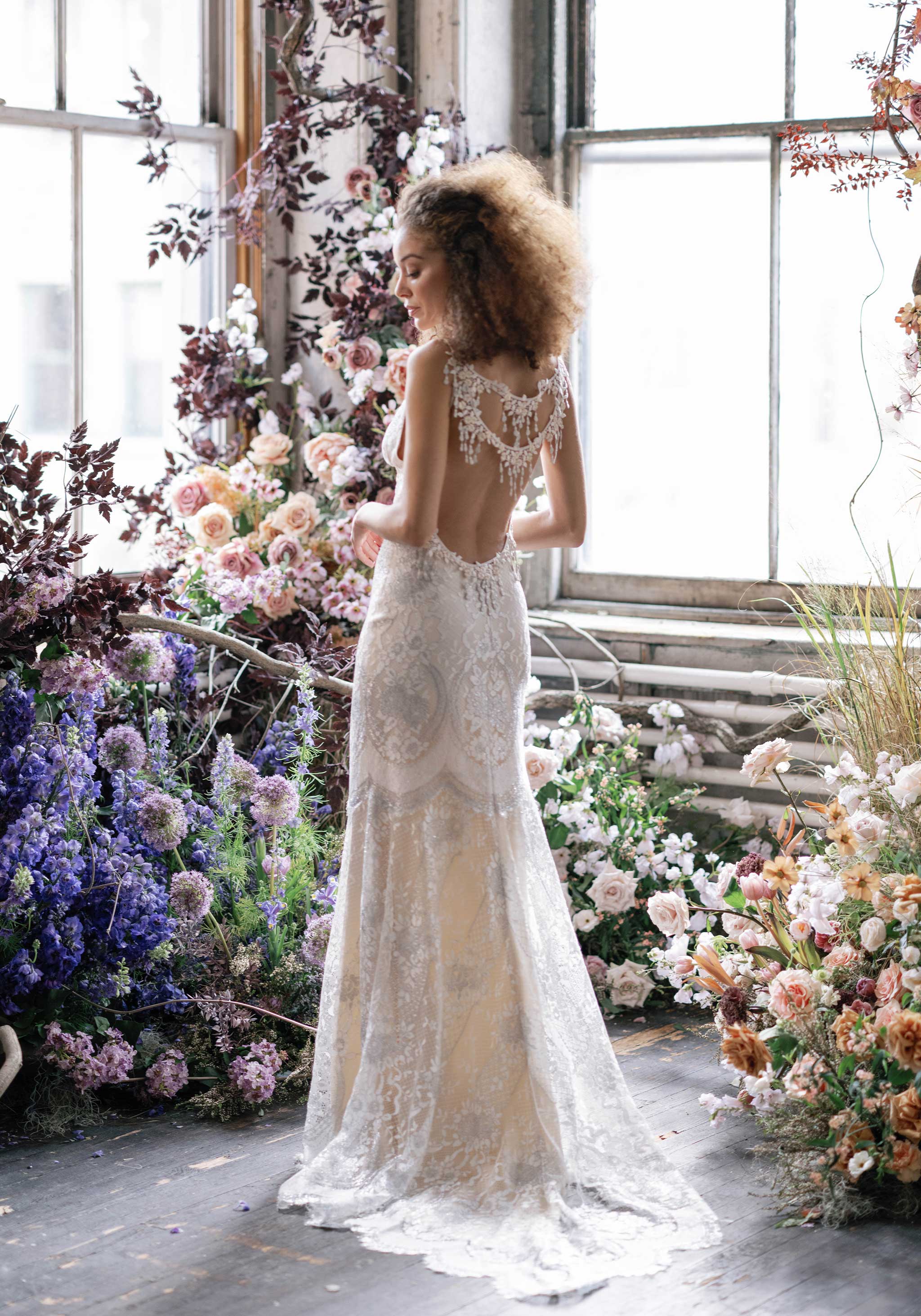 Low and open back lace wedding dress sheath style silhouette from Claire Pettibone