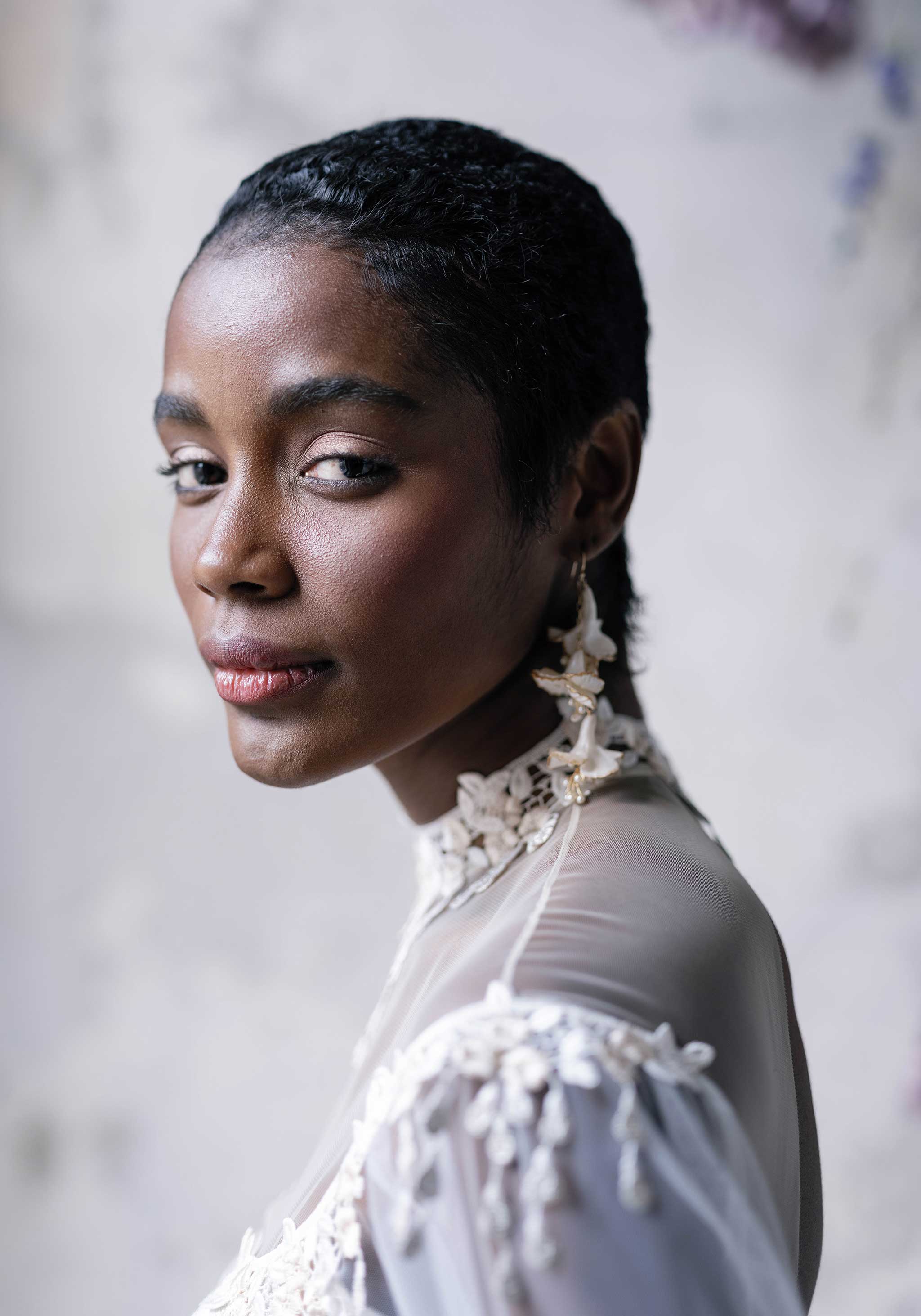 Model wearing designer silk wedding dress Riviere by Claire Pettibone