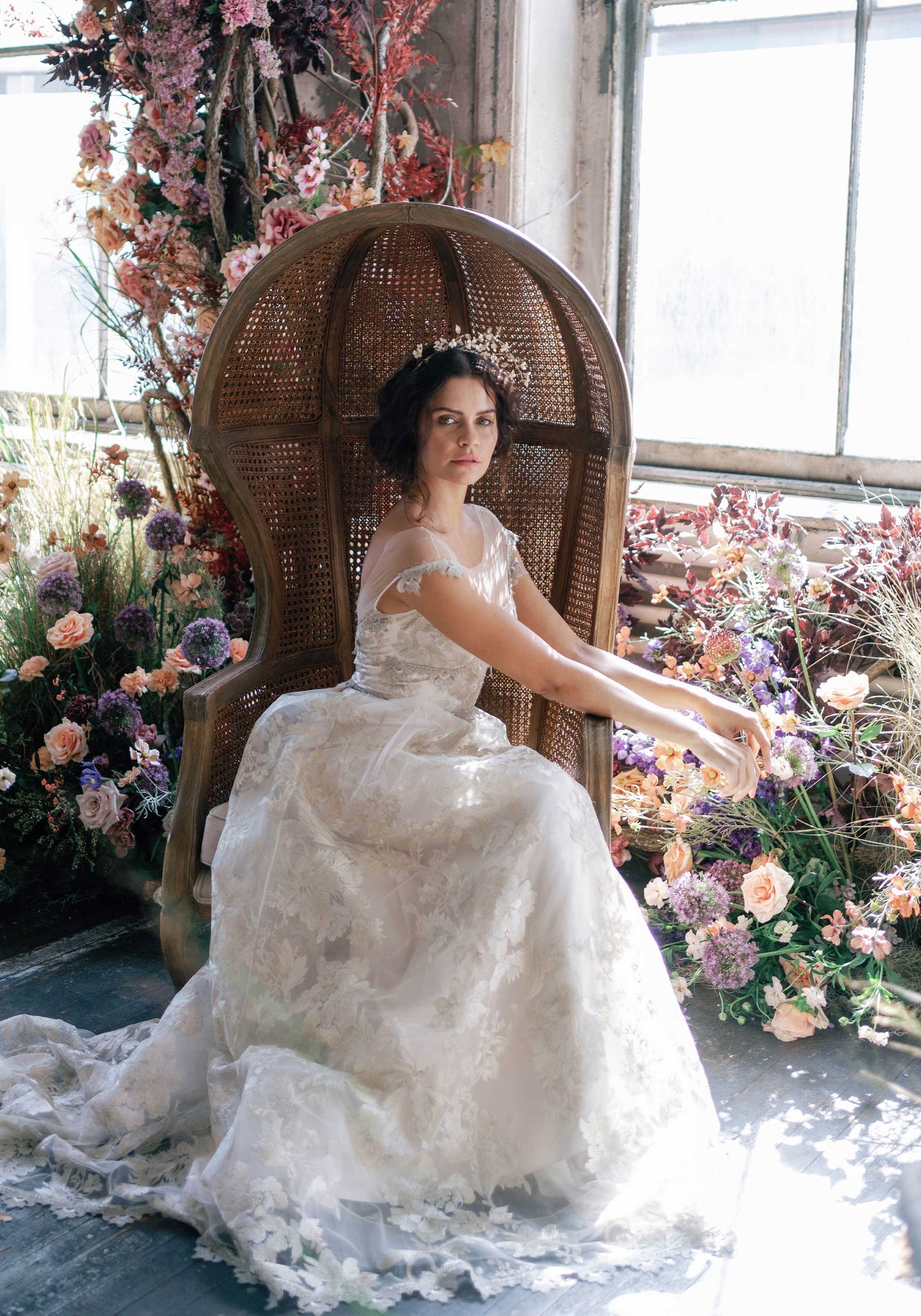Model in chair in Vermeil Gold Wedding dress by Claire Pettibone
